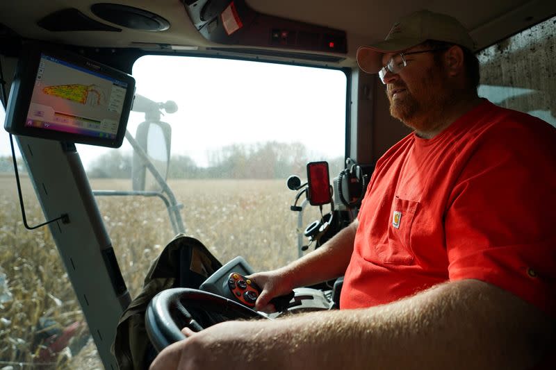 Paul Hodgen harvests corn from a field using a combine on his farm in Roachdale
