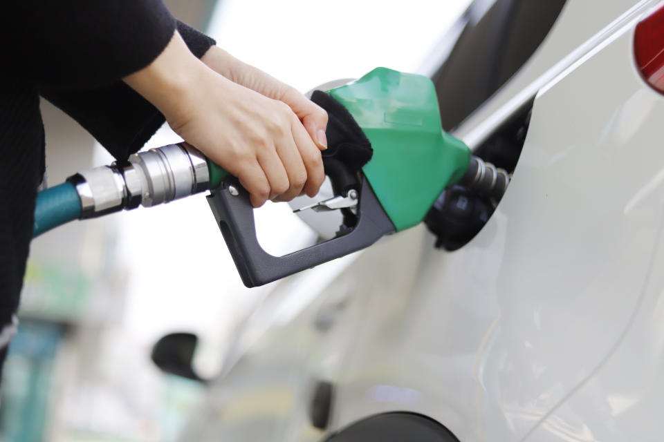 Cropped Hand Of Woman Refueling Car