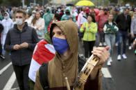A demonstrator wearing a face mask to protect against coronavirus attends an opposition rally to protest the official presidential election results in Minsk, Belarus, Sunday, Sept. 27, 2020.Hundreds of thousands of Belarusians have been protesting daily since the Aug. 9 presidential election. (AP Photo/TUT.by)
