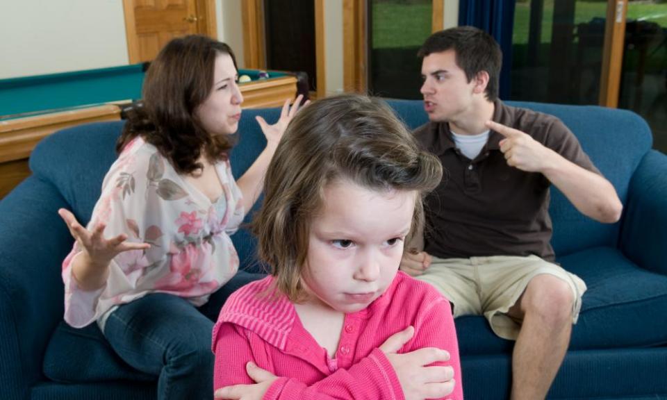 Parents rowing in front of child