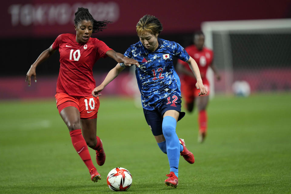FILE - Japan's Jun Endo (12) and Canada's Ashley Lawrence (10) battle for the ball during a women's soccer match at the 2020 Summer Olympics, Wednesday, July 21, 2021, in Sapporo, Japan. (AP Photo/Silvia Izquierdo, File)