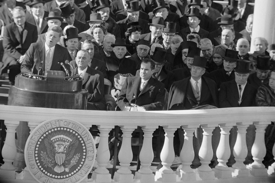 President John F Kennedy gives his inaugural address at the Capitol in Washington, on Jan. 20, 1961, after he took oath of office. Listening in front row of inaugural seats, from left, are, Vice President Lyndon B Johnson, Richard M Nixon, Kennedy's campaign opponent, Sen John Sparkman of Alabama, and former President Harry Truman. (AP Photo)