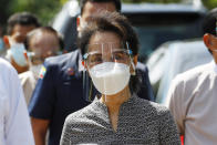 Myanmar leader Aung San Suu Kyi wearing a protective face mask and shield walks to greet supporters as she leaves after a demonstration of the voting for the upcoming Nov. 8 general elections, Tuesday, Oct. 20, 2020, in Naypyitaw, Myanmar. (AP Photo/Aung Shine Oo)