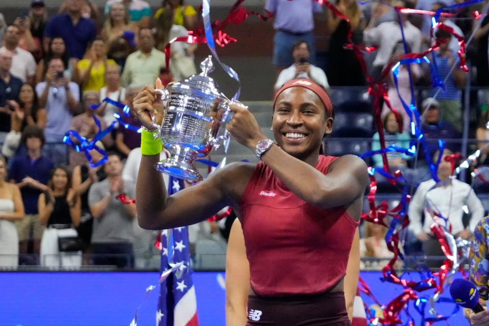 Coco Gauff raises the championship trophy after beating Aryna Sabalenka in the US Open women's final.