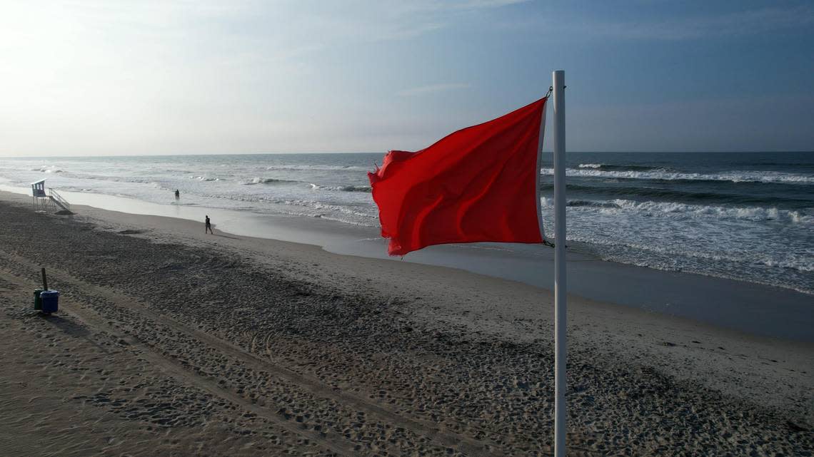 A red flag flying recently at Emerald Isle warns beachgoers to expect dangerously strong currents and rough seas if they swim in the ocean.