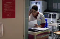 Nurse Elodie Proust gets a phone call at the emergency ward of the Rouvray psychiatric hospital, in Rouen, western France, Wednesday, Nov. 25, 2020. Lockdowns that France has used to fight the coronavirus have come at considerable cost to mental health. Surveying points to a surge of depression most acute among people without work, in financial hardship and young adults. (AP Photo/Thibault Camus)