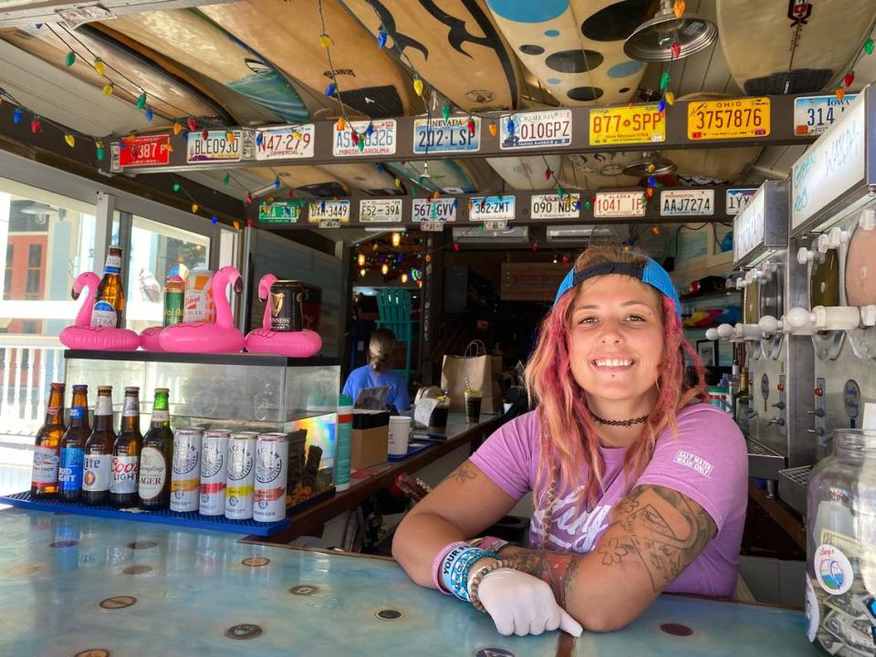 Mercedes Bennett, 27, a Duval Street service worker, sold cans of beer and hard seltzer to passersby on Duval Street on March 18, 2020.