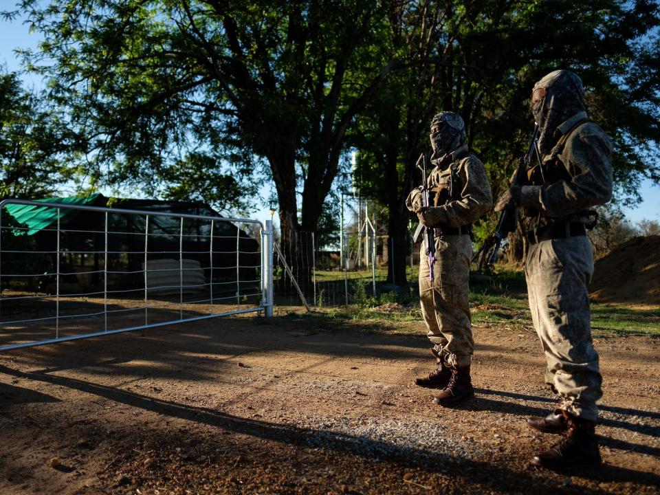 Two armed guards at the ranch of rhino breeder John Hume on October 16, 2017.