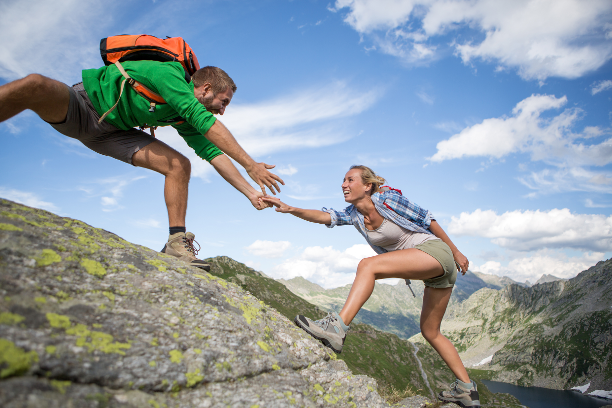 Couple climbing a high mountain