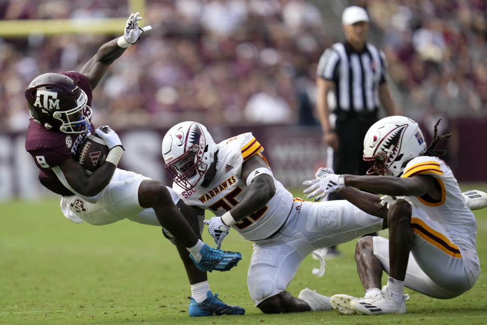 Texas A&M running back Le'Veon Moss (8) is knocked off his feet after a two-yard gain by Louisiana-Monroe linebacker Carl Glass Jr. (35) during the second quarter of an NCAA college football game Saturday, Sept. 16, 2023, in College Station, Texas. (AP Photo/Sam Craft)