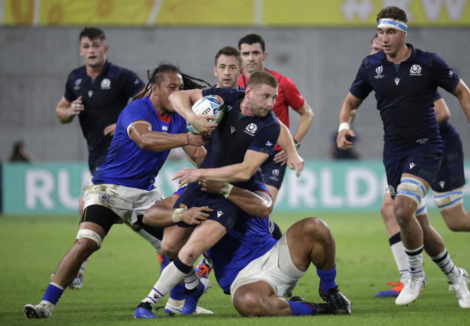 Scotland's Finn Russell runs at the Samoan defence during the Rugby World Cup Pool A game at Kobe Misaki Stadium between Scotland and Samoa in Kobe City, Japan, Monday, Sept. 30, 2019. (AP Photo/Aaron Favila)