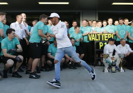 Formula One - F1 - Russian Grand Prix - Sochi, Russia - 30/04/17 - Mercedes Formula One driver Lewis Hamilton of Britain runs away as his team mate Valtteri Bottas of Finland poses for a picture after the race. REUTERS/Maxim Shemetov