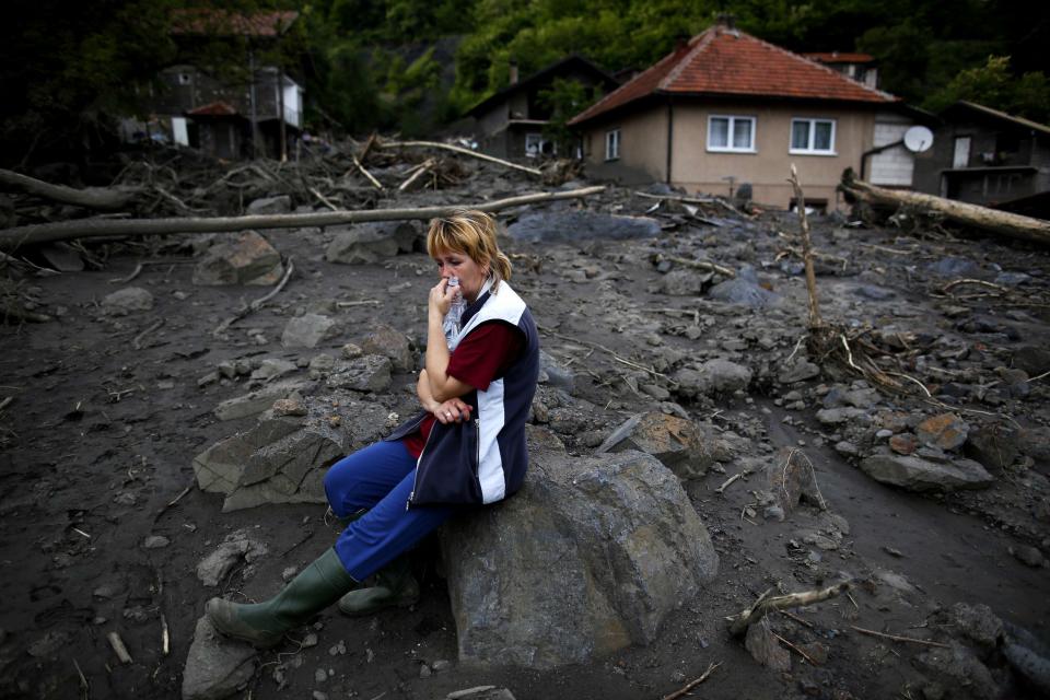 Fata Kovacevic reacts near her flood-damaged house in Topcic Polje