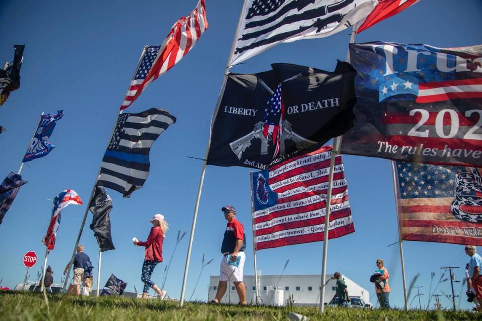 Flags blow in a stiff wind prior to a GOP rally featuring former President Donald Trump, at Wilmington International Airport Friday, Sept. 23, 2022.