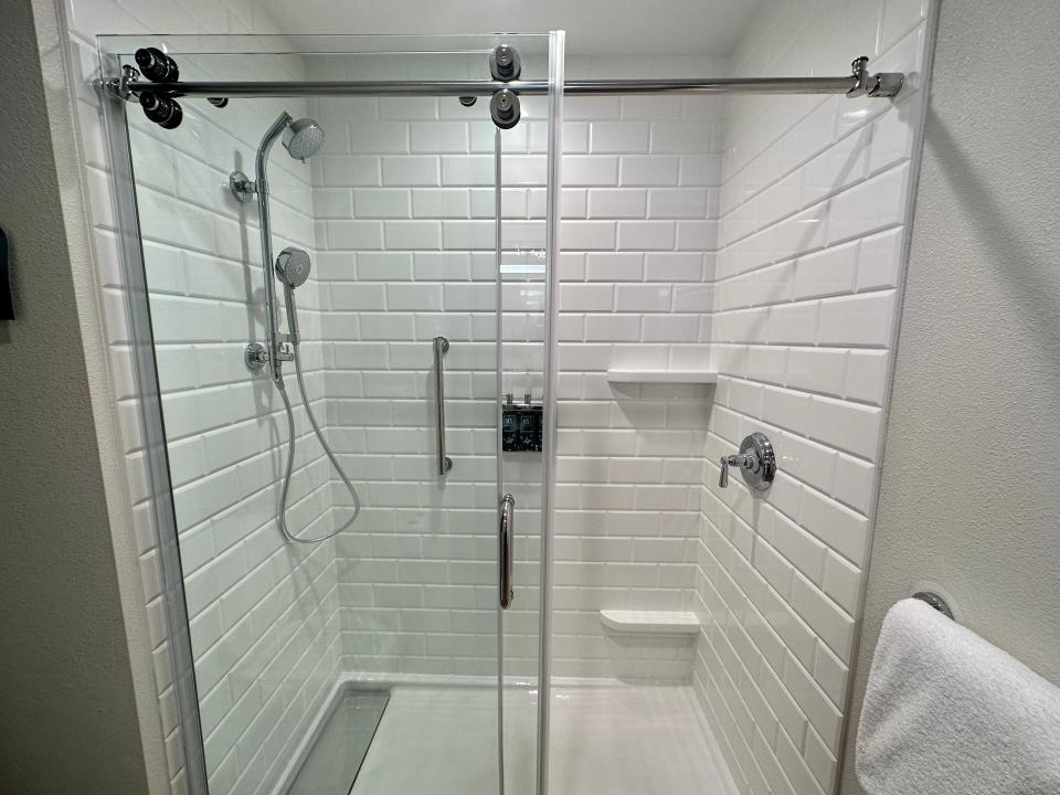 Large white shower with sliding glass doors in Dollywood HeartSong resort