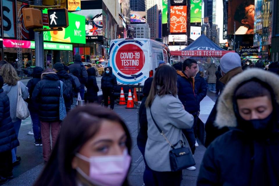 FILE – People wait in a long line to get tested for COVID-19 in Times Square, New York, Dec. 20, 2021. (AP Photo/Seth Wenig, file)