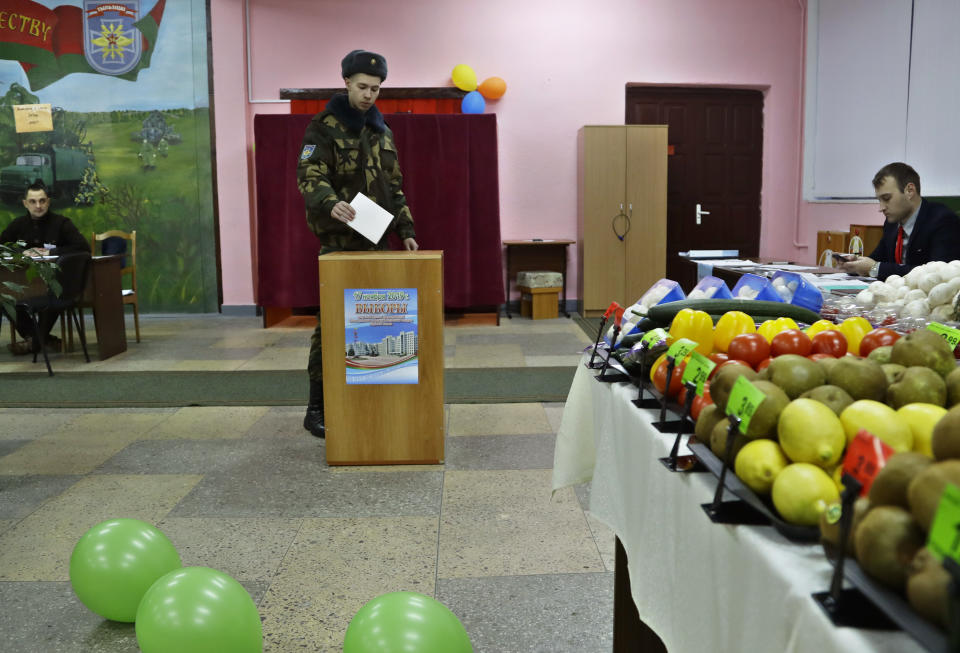 A Belarus' Army serviceman casts his ballot at a polling station during parliamentary elections, in Minsk, Belarus, Sunday, Nov. 17, 2019. (AP Photo/Sergei Grits)