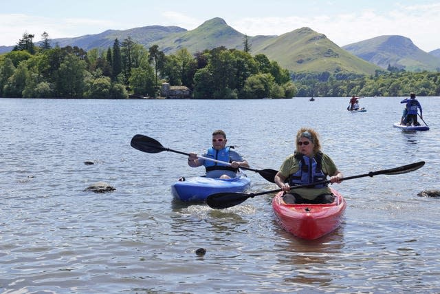 People enjoy the weather at Derwentwater in the Lake District National Park near Keswick 