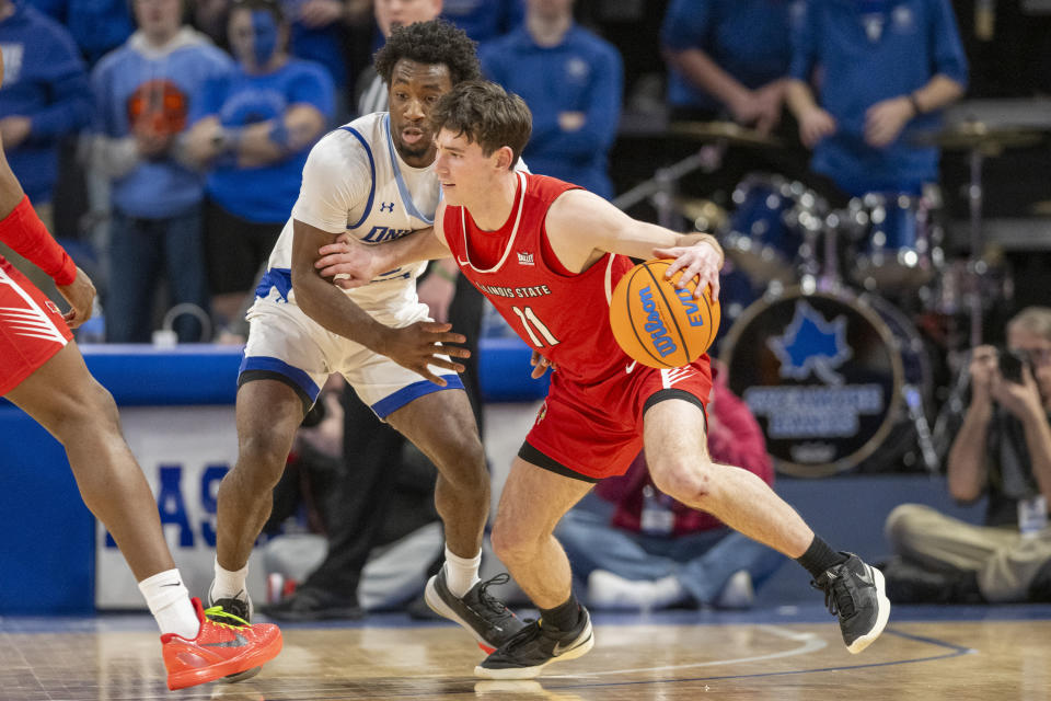 Illinois State guard Johnny Kinziger (11) is defended by Indiana State guard Isaiah Swope during the second half of an NCAA college basketball game Tuesday, Feb. 13, 2024, in Terre Haute, Ind. (AP Photo/Doug McSchooler)