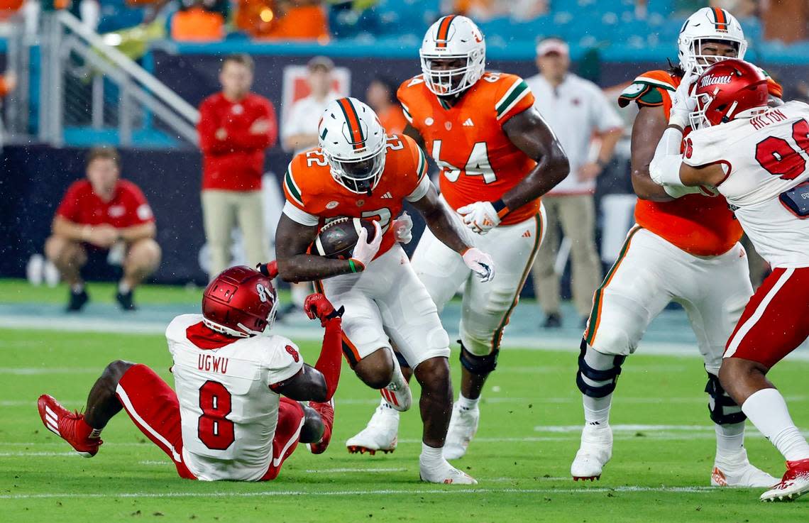 Miami Hurricanes running back Mark Fletcher Jr. (22) goes up against Miami of Ohio Redhawks defensive lineman Brian Ugwu (8) in the first half in Miami Gardens, Florida on Friday, September 1, 2023.