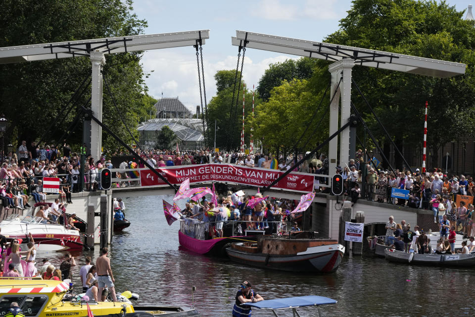 Hundreds of thousands of people lined canals in the Dutch capital to watch the colorful spectacle of the Pride Canal Parade return for the 25th edition after the last two events were canceled due to the COVID-19 pandemic, in Amsterdam, Netherlands, Saturday, Aug. 6, 2022. (AP Photo/Peter Dejong)