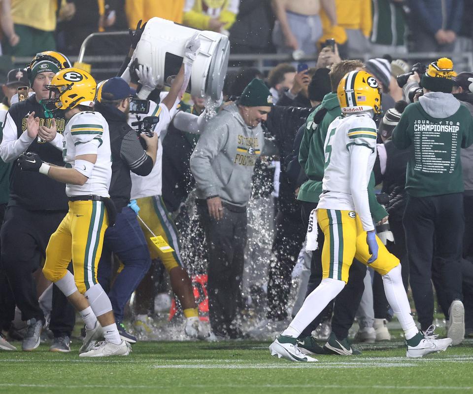 St. Edward head coach Tom Lombardo is doused by players to celebrate winning the Division I state final vs. Springfield, Friday, Dec. 1, 2023, in Canton.