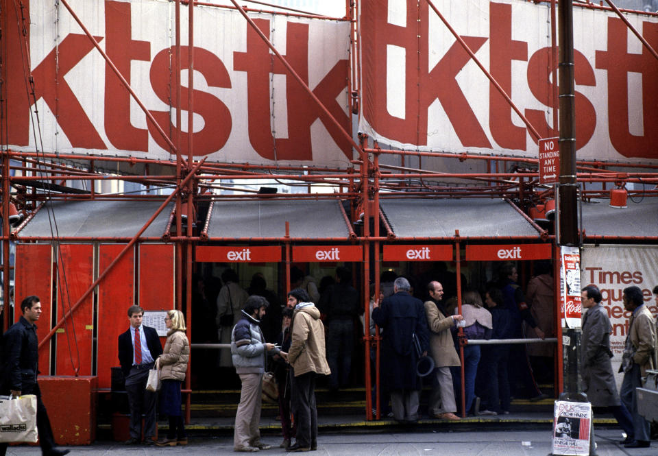 FILE - People gather in front of the TKTS booth, where discounted tickets for Broadway and off-Broadway shows are sold on the day of the performance, in New York's Times Square, March 11, 1982. The TKTS booth in Times Square, which has become part of the city's visual and financial DNA and a key part in keeping Broadway going, celebrates its 50th birthday this week. (AP Photo/Suzanne Vlamis, File)