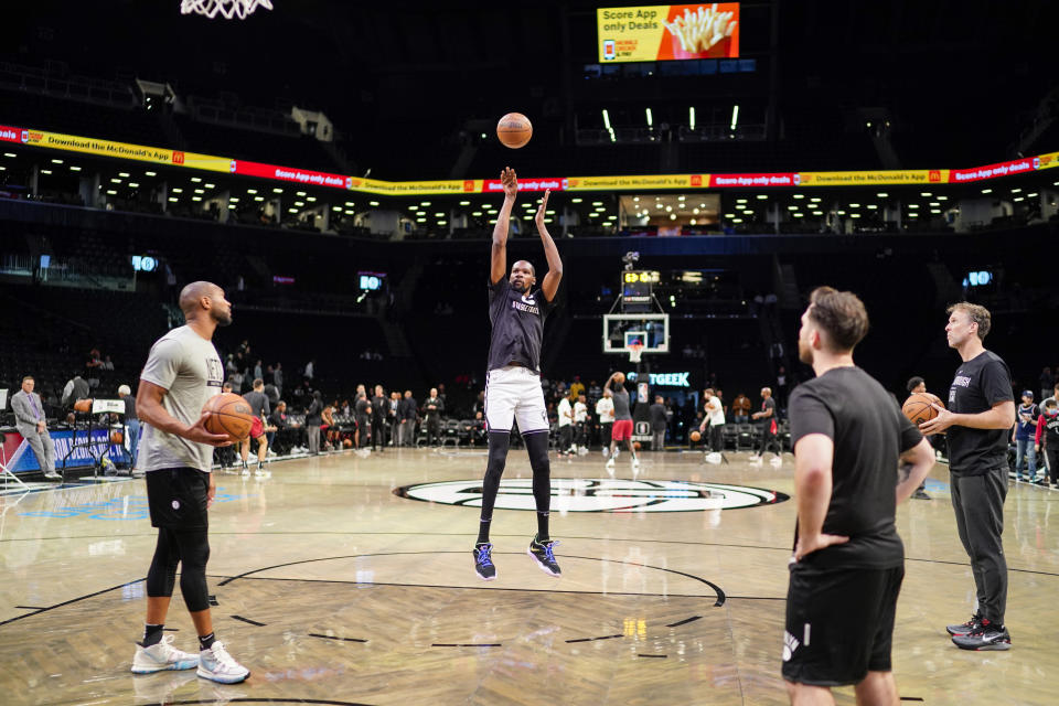 Brooklyn Nets forward Kevin Durant, center, warms up before a preseason NBA basketball game against the Miami Heat, Thursday, Oct. 6, 2022, in New York. (AP Photo/Eduardo Munoz Alvarez)