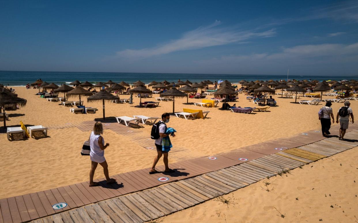 Beachgoers make their way onto the sand at Falesia Beach in Vilamoura, Portugal - Bloomberg