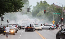 Smoke rises as police attempt to disperse protesters on Page Ave. after a shooting incident in St. Louis, Missouri August 19, 2015. REUTERS/Kenny Bahr