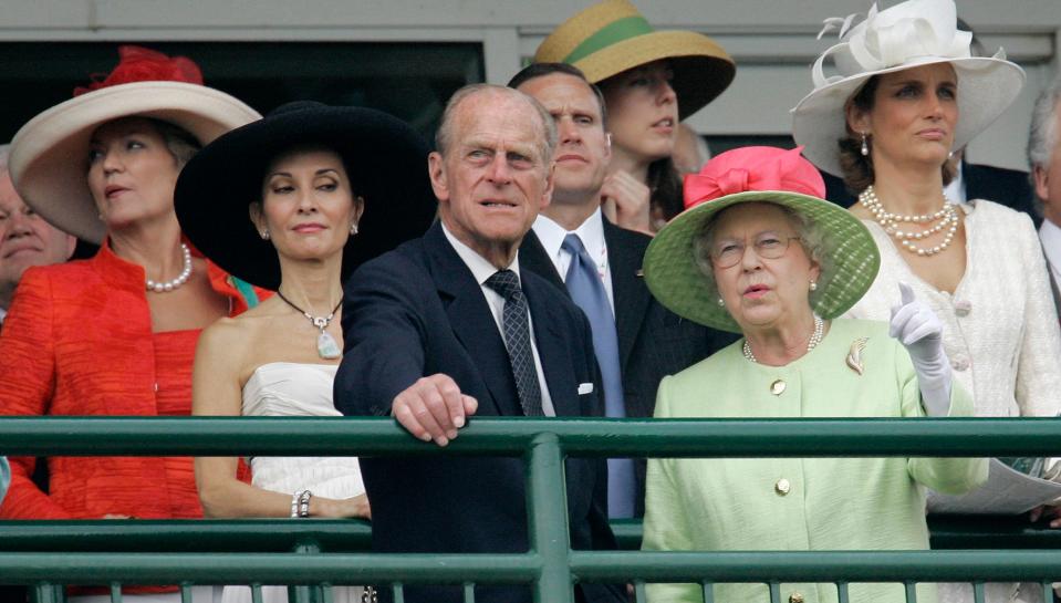Queen Elizabeth II chats with Prince Philip as Susan Lucci (black hat) looks on at the 133rd Kentucky Derby at Churchill Downs in Louisville, Ky., Saturday, May 5, 2007. (AP Photo/Rob Carr)