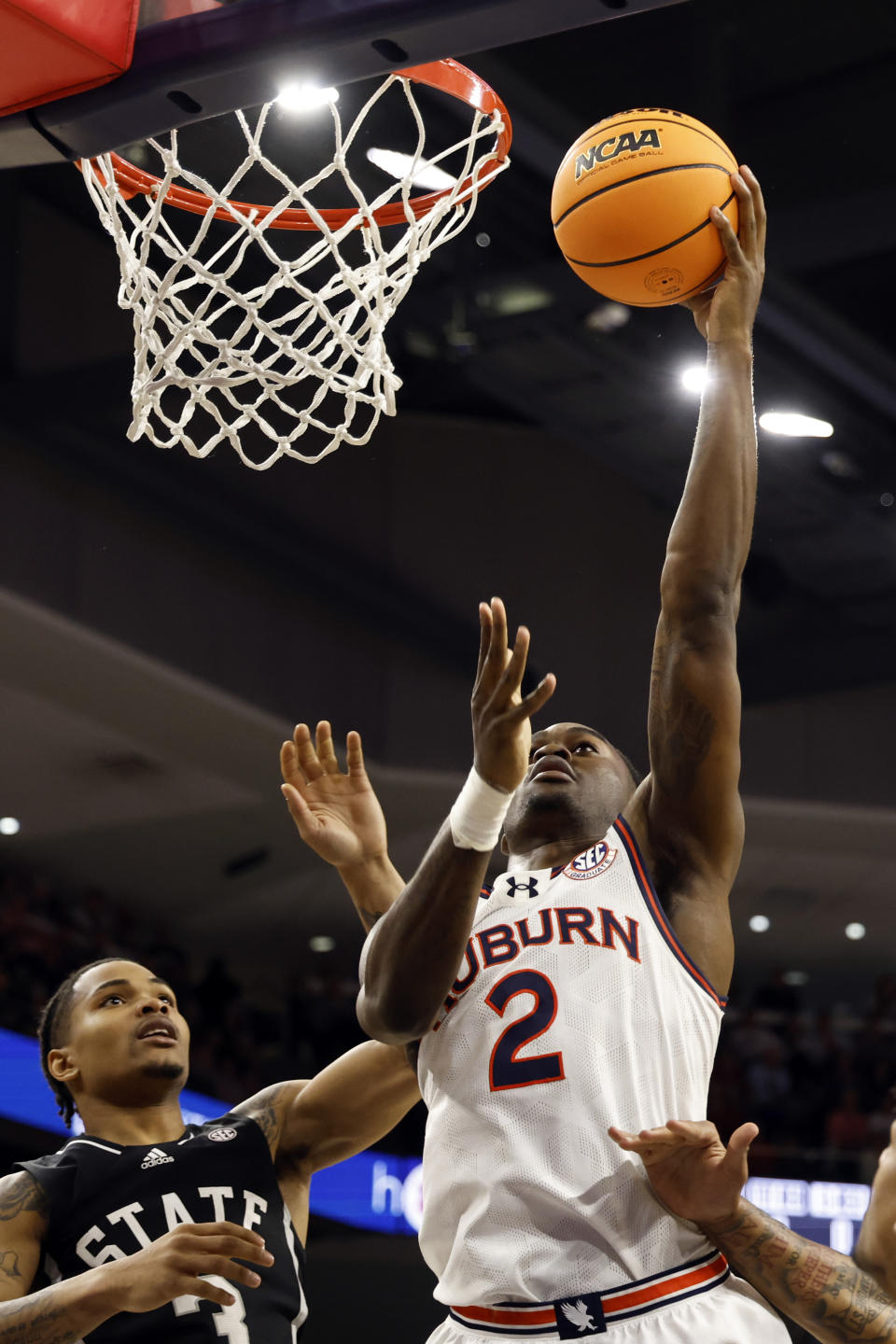 Auburn forward Jaylin Williams (2) lays in for the basket as Mississippi State guard Shakeel Moore (3) defends during the second half of an NCAA college basketball game, Saturday, March 2, 2024, in Auburn, Ala. (AP Photo/ Butch Dill)