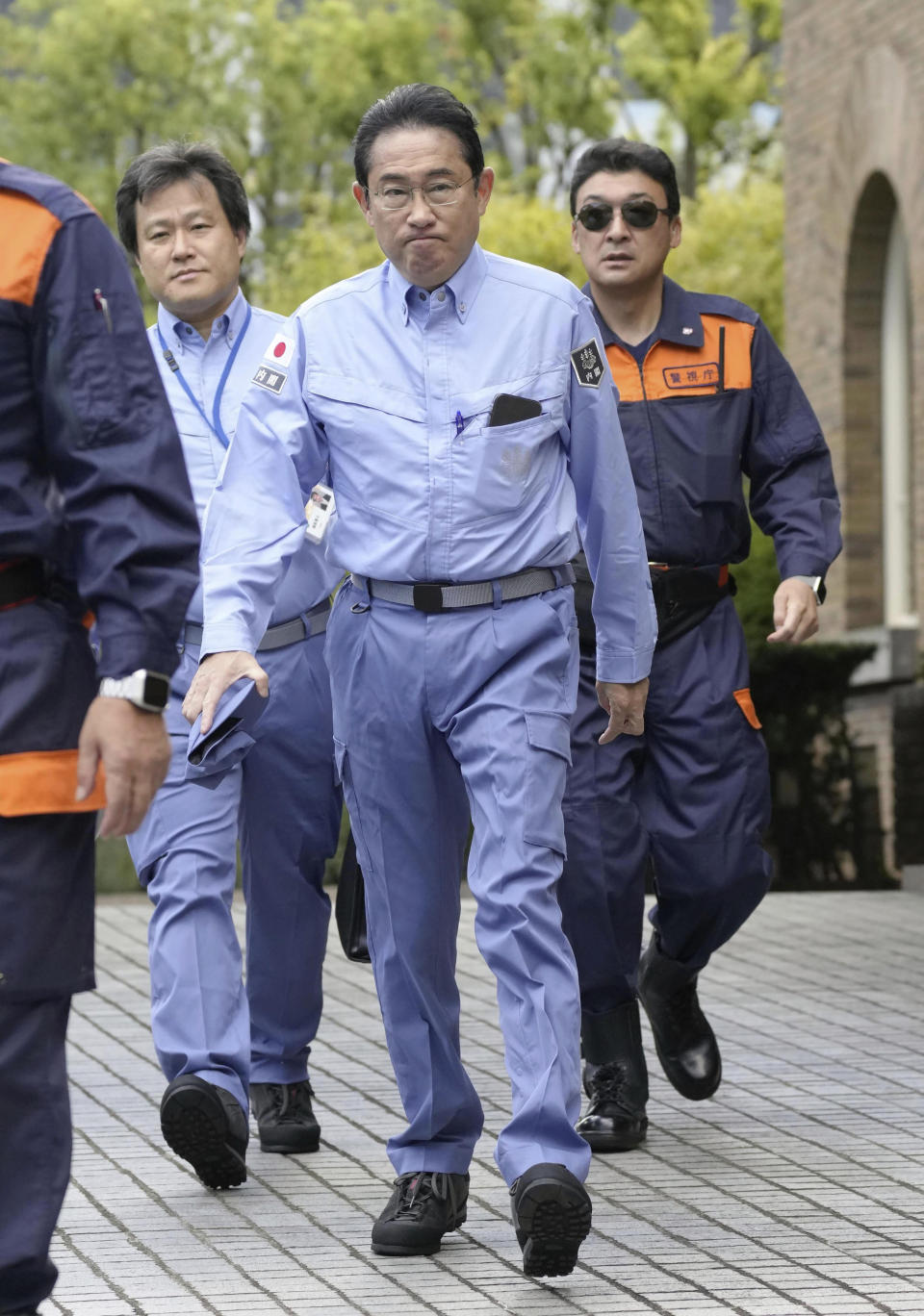 Japanese Prime Minister Fumio Kishida, center, leaves his official residence in Tokyo as the government holds a disaster drill Friday, Sept. 1, 2023. On Friday, Japan marked the centennial of the 1923 Great Kanto Quake that killed more than 100,000. (Kyodo News via AP)