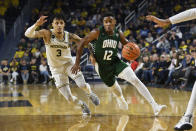 Ohio guard Jaylin Hunter, right, dribbles past Michigan guard Jaelin Llewellyn in the first half of an NCAA college basketball game, Sunday, Nov. 20, 2022, in Ann Arbor, Mich. (AP Photo/Jose Juarez)