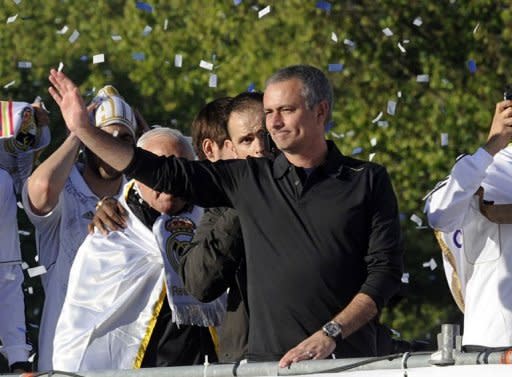 Real Madrid's coach Jose Mourinho celebrates on an open bus at Cibeles square