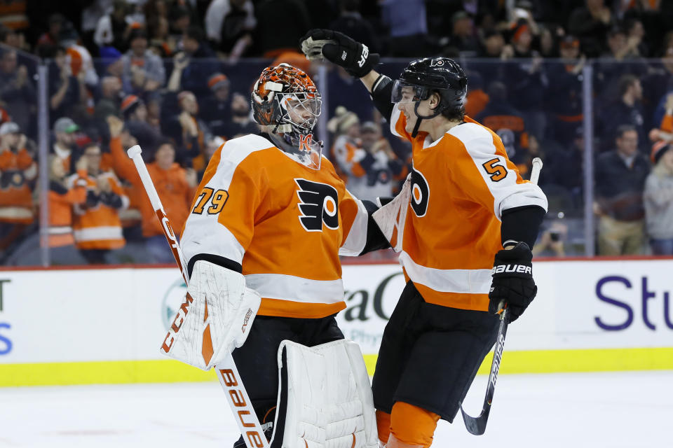 Philadelphia Flyers' Carter Hart, left, and Philippe Myers celebrate after the team's NHL hockey game against the Washington Capitals, Wednesday, Jan. 8, 2020, in Philadelphia. (AP Photo/Matt Slocum)