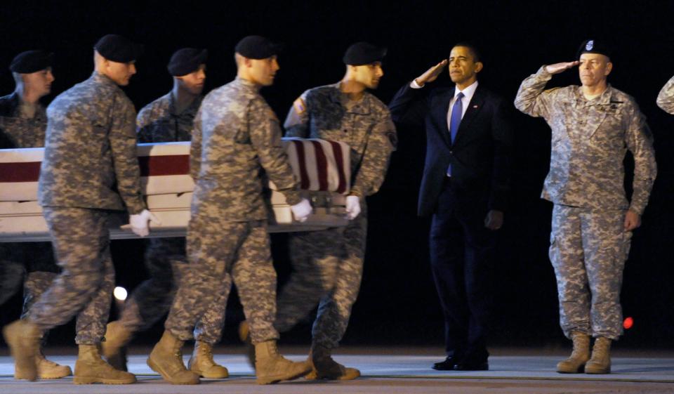 President Barack Obama salutes as a transfer case containing the remains of Army Sgt. Dale R. Griffin, 29, of Terre Haute, Indiana, who died in Afghanistan, arrives at Dover Air Force Base in Delaware on Oct. 29, 2009.