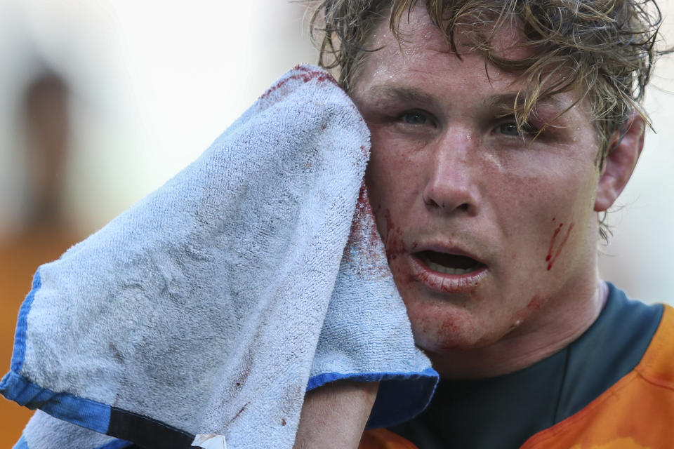 Australia's captain Michael Hooper wipes blood from his face following the Rugby Championship game between the All Blacks and the Wallabies in Perth, Australia, Sunday, Sept. 5, 2021. (AP Photo/Gary Day)