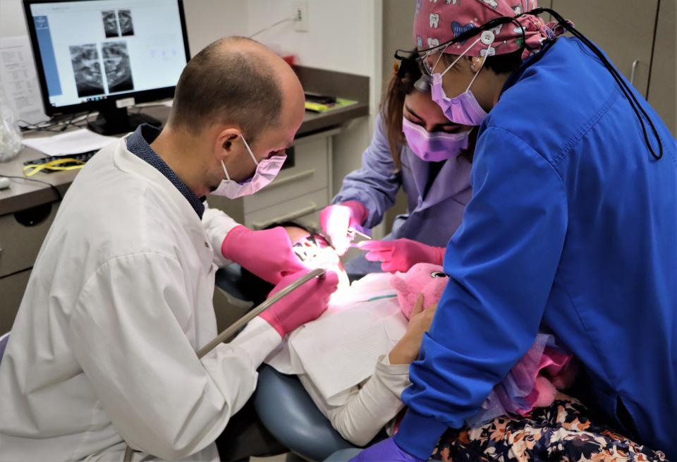 Dentist Gene Hilton treats a young patient during the Give Kids a Smile free clinic on Feb. 3, 2023, at the Health and Human Performance Center on the San Juan College campus.