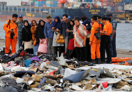 Families of passengers of Lion Air flight JT610 stand as they look at the belongings of the passengers at Tanjung Priok port in Jakarta, Indonesia, October 31, 2018. REUTERS/Beawiharta