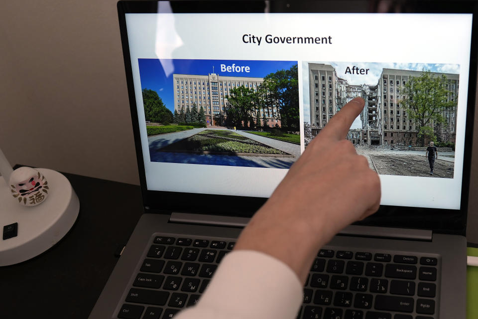 Ukrainian Dmytro Remez points at an image showing the damage of a city government building seen on PC screen, at his dormitory room during an interview with the Associated Press in Tokyo, on Feb. 15, 2023. Remez, 24, a fledgling medical doctor studying at Juntendo University, is among the 2,291 Ukrainians who have moved to Japan since the war with Russia began a year ago. (AP Photo/Shuji Kajiyama)