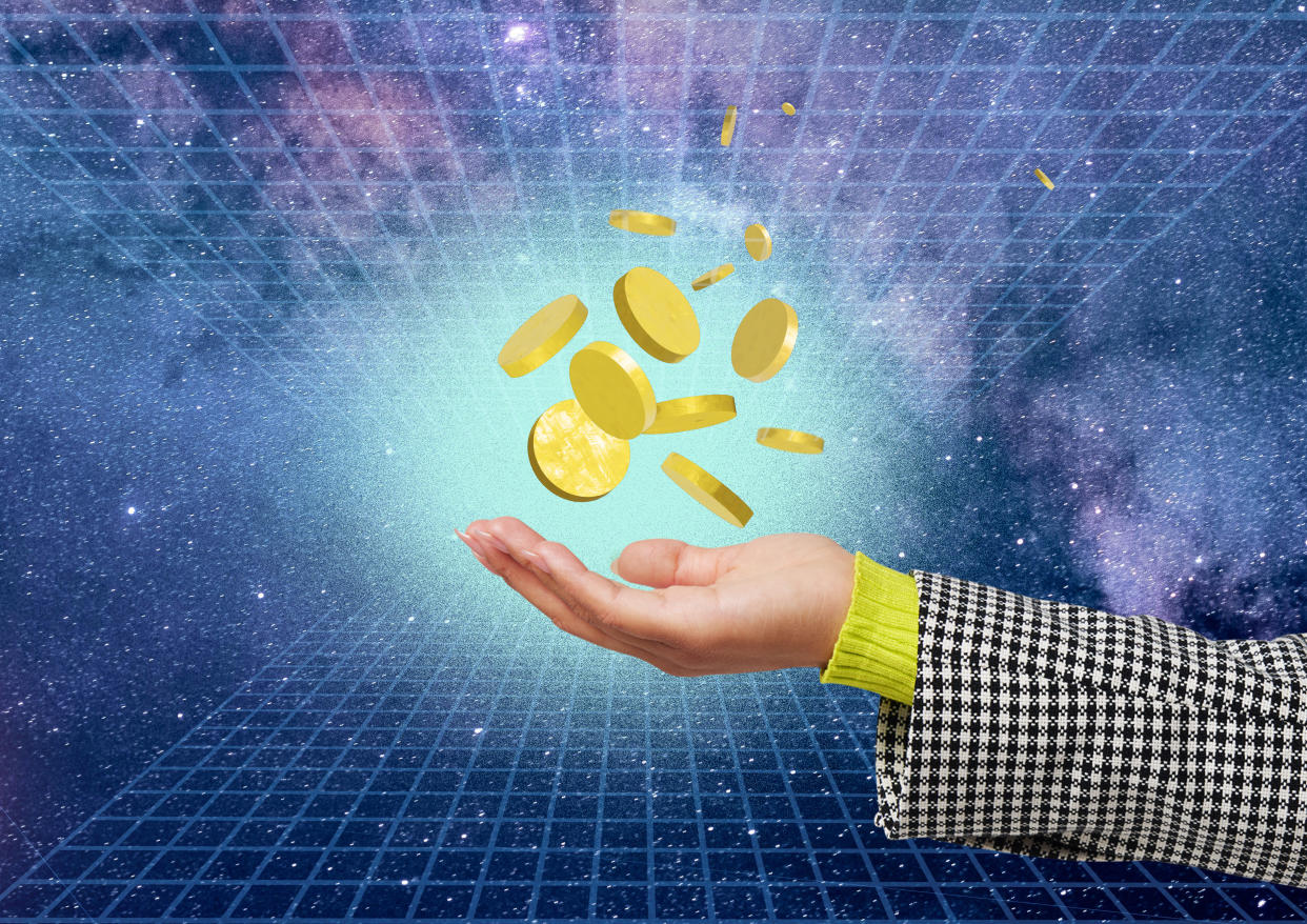 A collection of gold coins hove above a human hand in a virtual space crypto