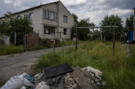 A cat makes its way past damaged homes, as civilians rebuild their homes after being destroyed by Russian strikes, Yahidne village, northern Chernihiv region, Ukraine, Wednesday, June 29, 2022. A few months after Russian troops retreated from Yahidne, the village has gradually returned to life. People are repairing their homes, and a strong wind occasionally picks up the bitter smell of ashes. (AP Photo/Nariman El-Mofty)