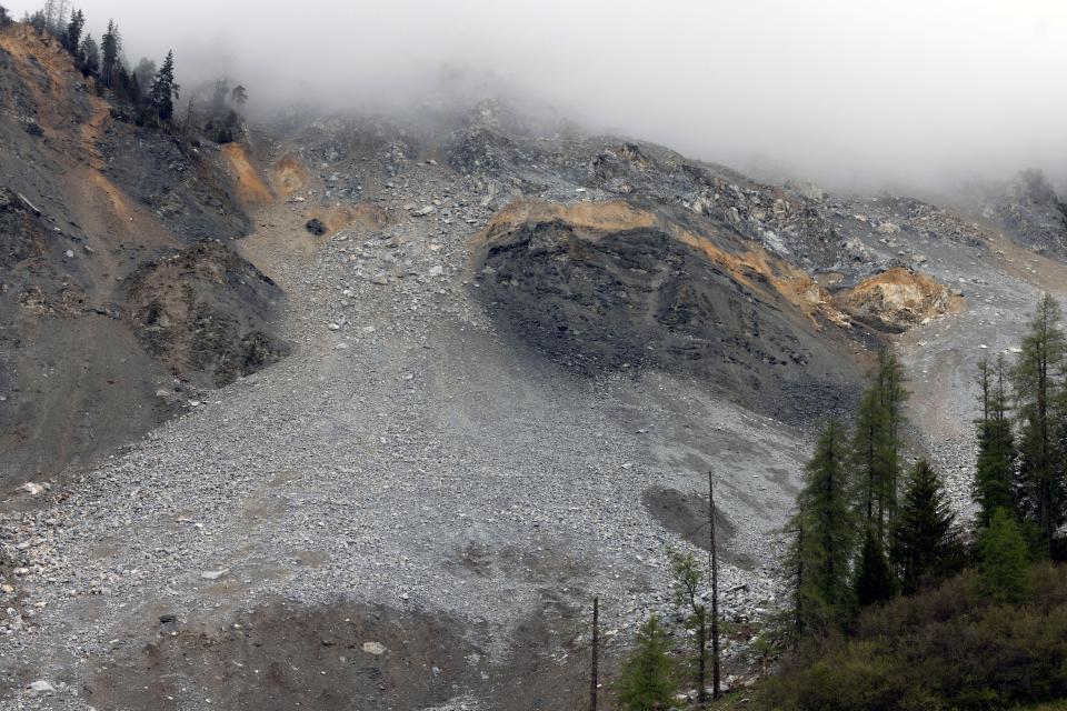 mist covers rocks that threaten to fall onto the village of Brienz-Brinzauls, Switzerland