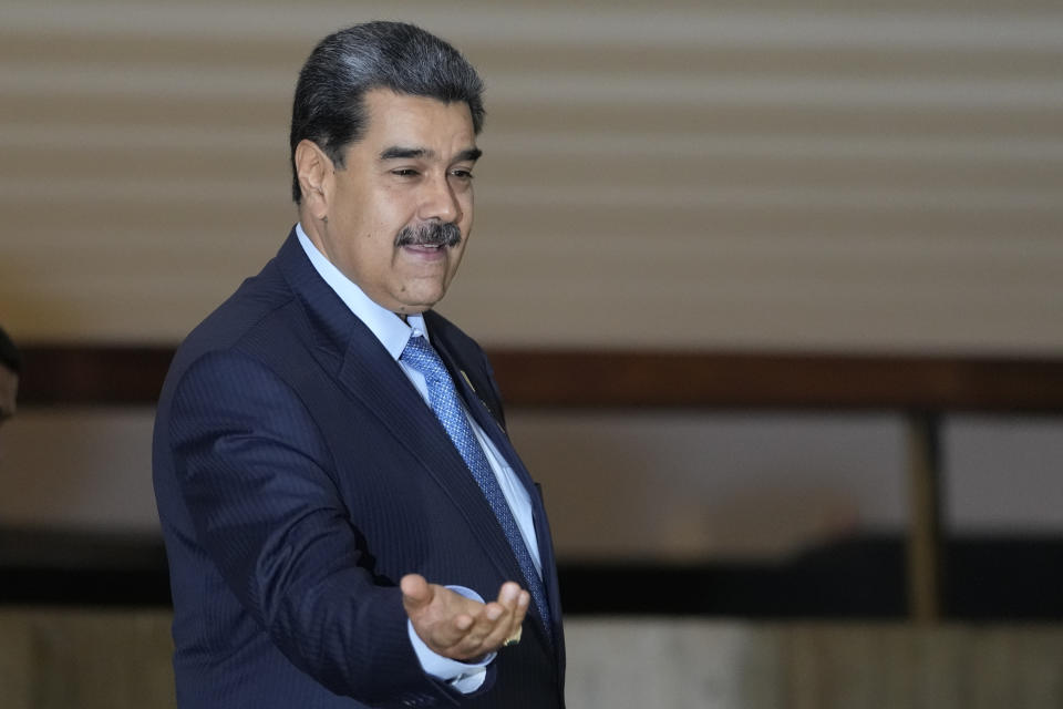 Venezuela's President Nicolas Maduro gestures to the media after attending the South American Summit at Itamaraty palace in Brasilia, Brazil, Tuesday, May 30, 2023. South America's leaders are gathering as part of Lula's attempt to reinvigorate regional integration efforts. (AP Photo/Andre Penner)