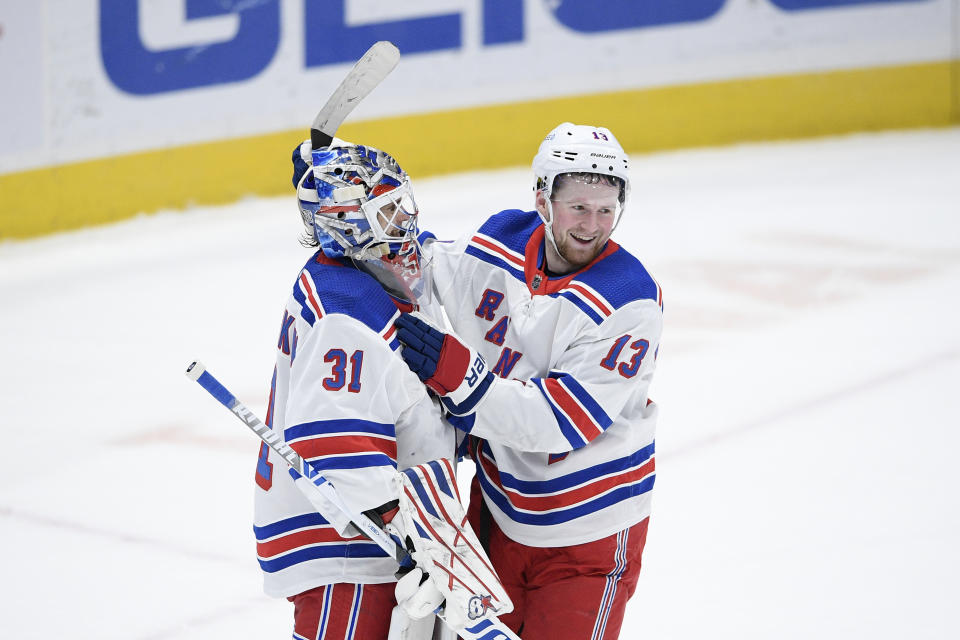 New York Rangers goaltender Igor Shesterkin (31) and left wing Alexis Lafrenière (13) celebrate after an NHL hockey game against the Washington Capitals, Saturday, Feb. 20, 2021, in Washington. The Rangers won 4-1. (AP Photo/Nick Wass)