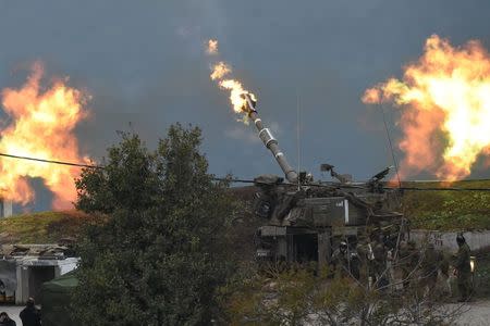 An Israeli artillery gun fires a shell into Lebanon, after a roadside bomb exploded next to an Israeli military border patrol near the Shebaa Farms area on Monday, near Kiryat Shmona, Israel, January 4, 2016. REUTERS/Ancho Gosh/Jinipix