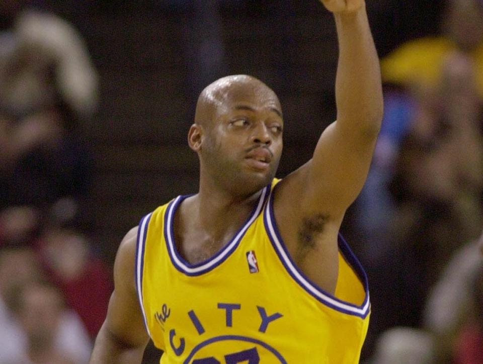 Golden State Warriors guard Nick Van Exel celebrates after hitting a 3-point shot against the Los Angeles Lakers.