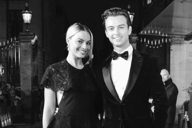 <p>Thomas Alexander/BAFTA via Getty </p> Margot Robbie poses with her younger brother, Cameron, at the EE British Academy Film Awards in February 2020.