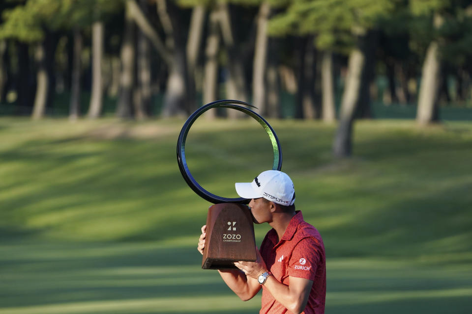 Collin Morikawa of the United States kisses the trophy after winning the PGA Tour Zozo Championship at the Narashino Country Club in Inzai on the outskirts of Tokyo, Sunday, Oct. 22, 2023. (AP Photo/Tomohiro Ohsumi)